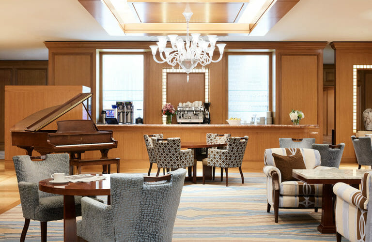 The Lobby Lounge at Little America Salt Lake with walk-up barista area for coffee, large seating area for dining and cocktails, and piano for entertainment.
