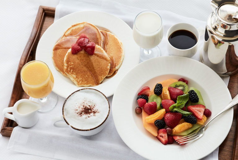 Pancakes, a fresh fruit plate, coffee and orange juice from in-room dining at the Little America Hotel in Salt Lake City.