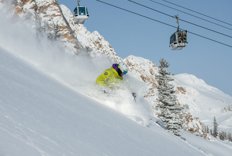 Man skiing down snowy hill at Snowbasin Resort.