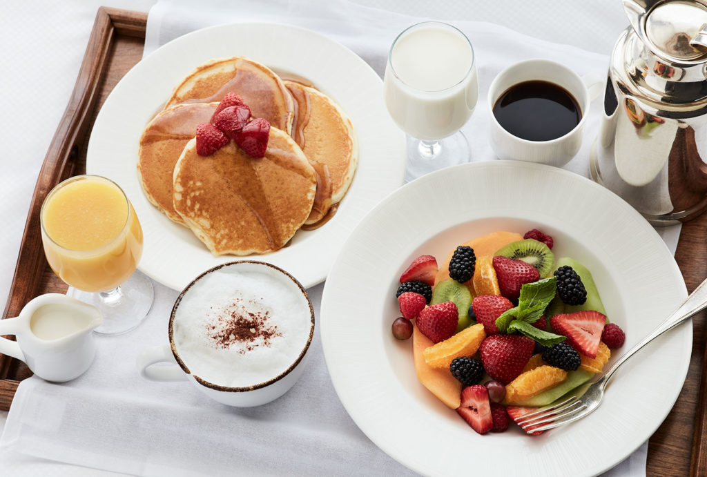 Pancakes, a fresh fruit plate, coffee and orange juice from in-room dining at the Little America Hotel in Salt Lake City.