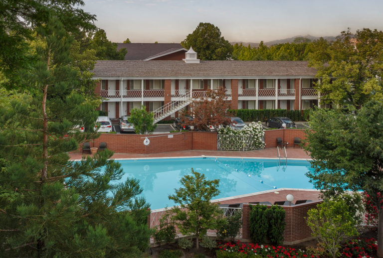 Exterior shot of Little America Hotel Courtside Rooms with direct outdoor access.