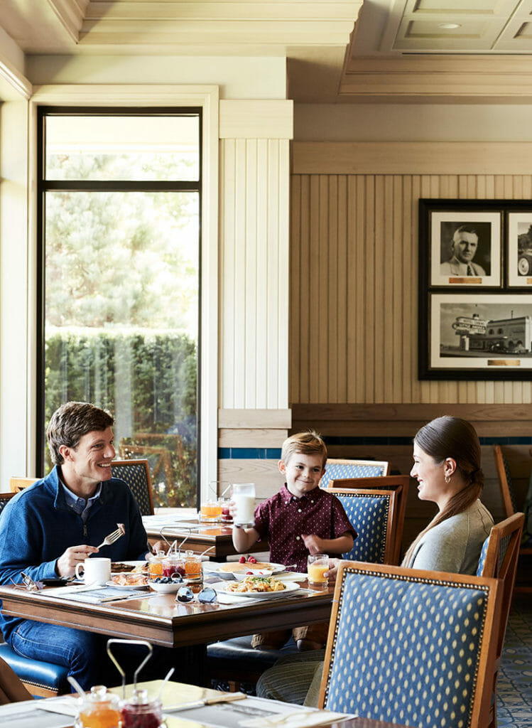 Family enjoying breakfast at a table in the Coffee Shop at the Little America Hotel