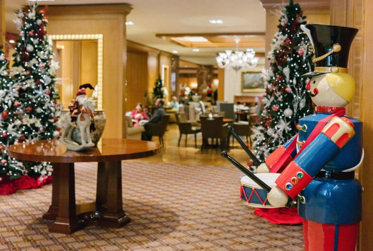Life-size nutcracker and Christmas tree decorations in the Little America Lobby Lounge